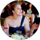 Meghan talking at a wedding reception table